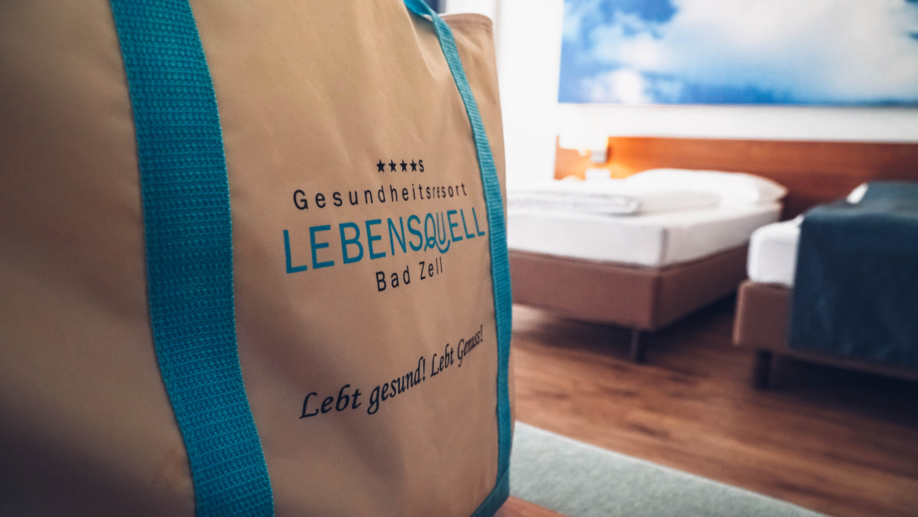Im Vordergrund die Badetasche der Hotel Lebensquell und im Hintergrund zwei Betten